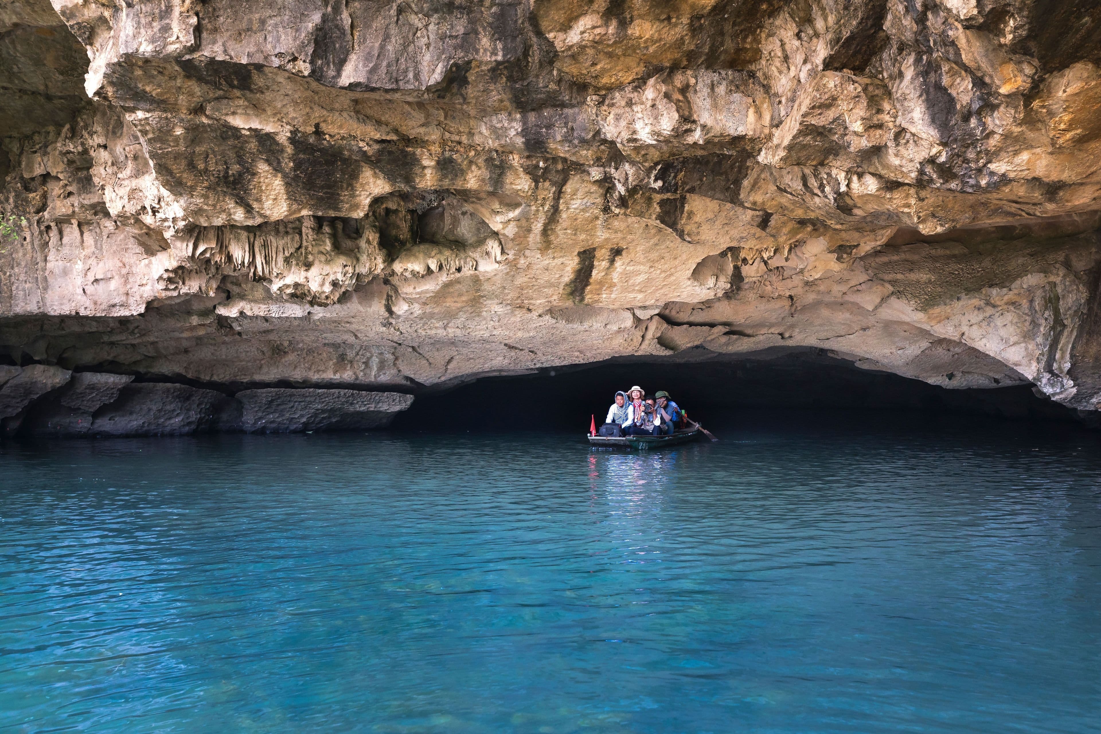 A boat entering a limestone sea cave, Baratang, Andaman