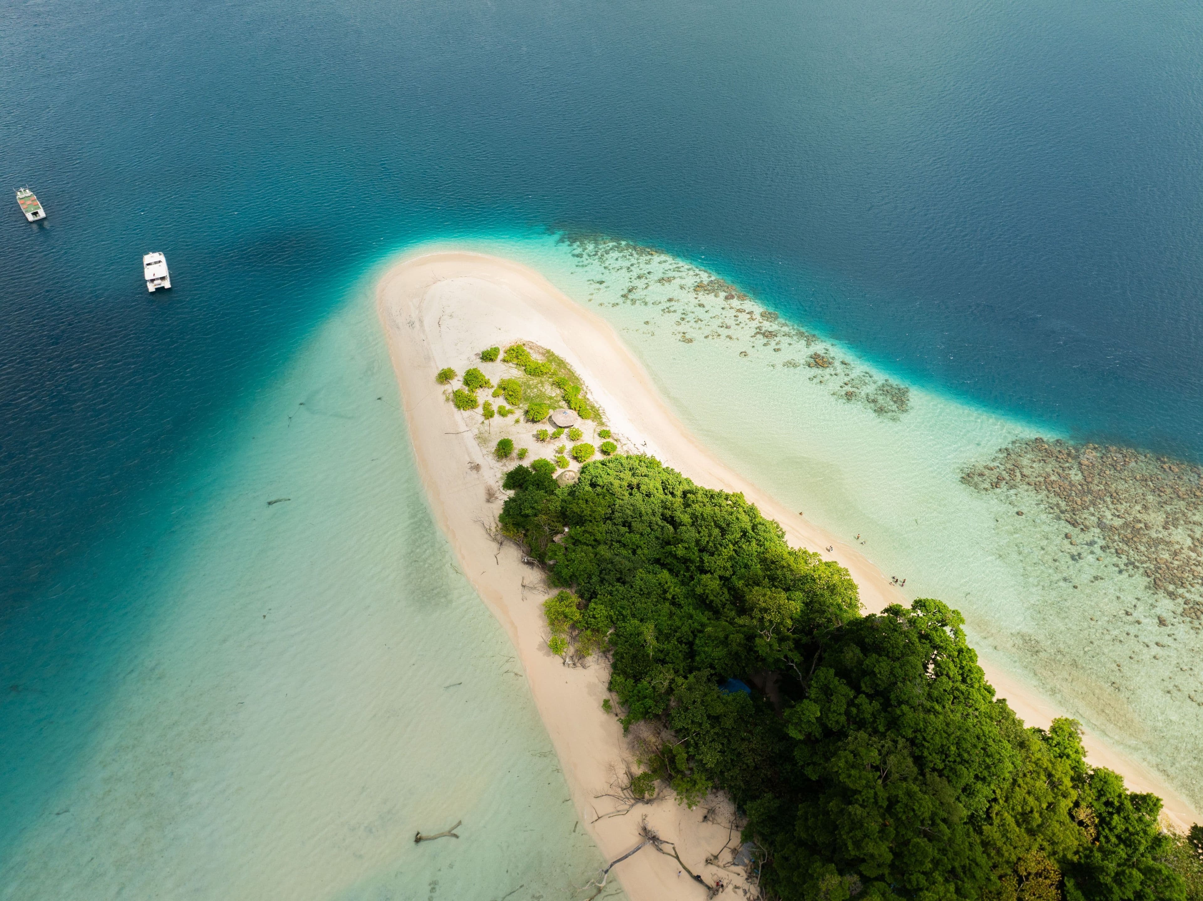 Aerial view of a white-sand Andaman islet ringed by turquoise water