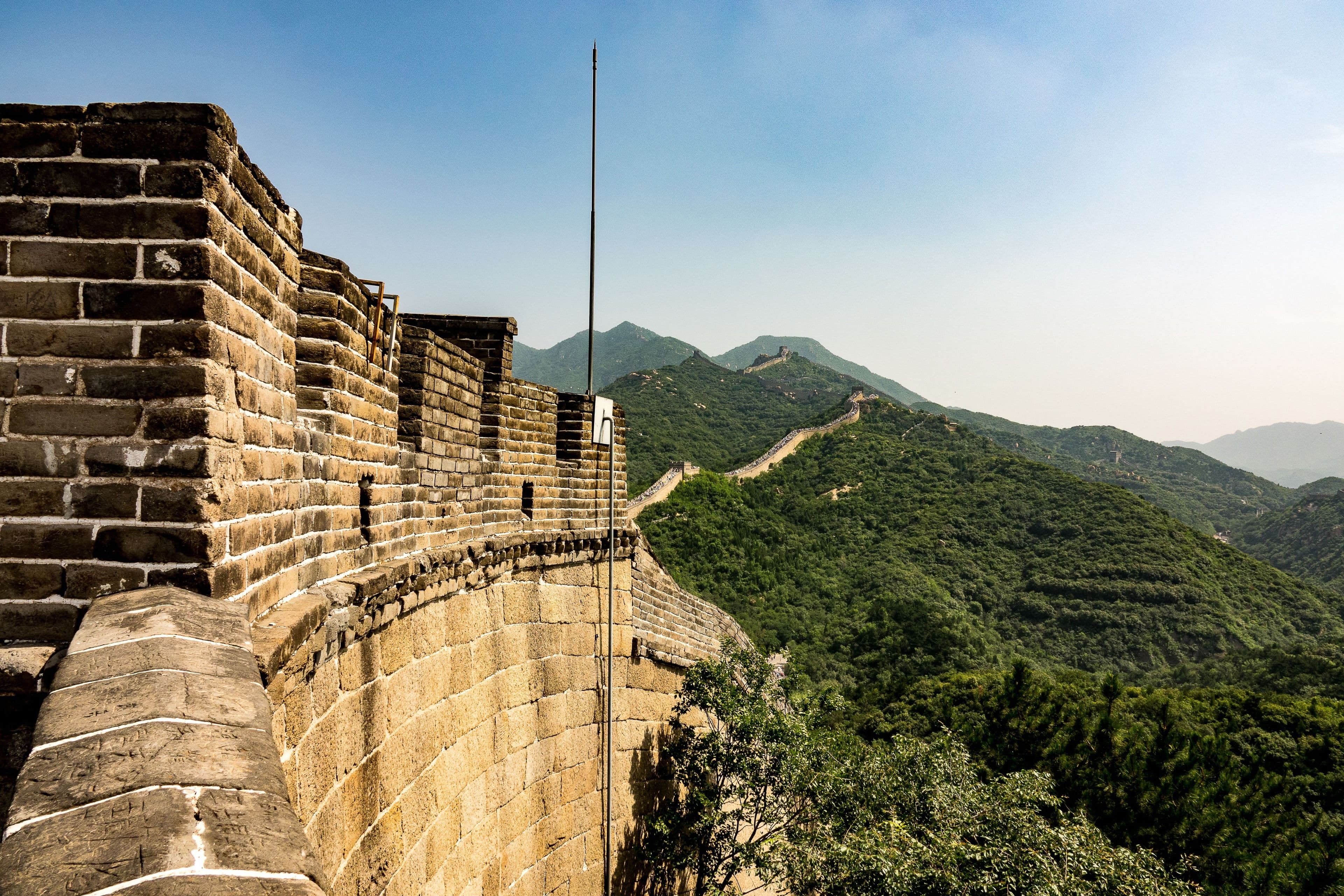 The Great Wall of China over green hills