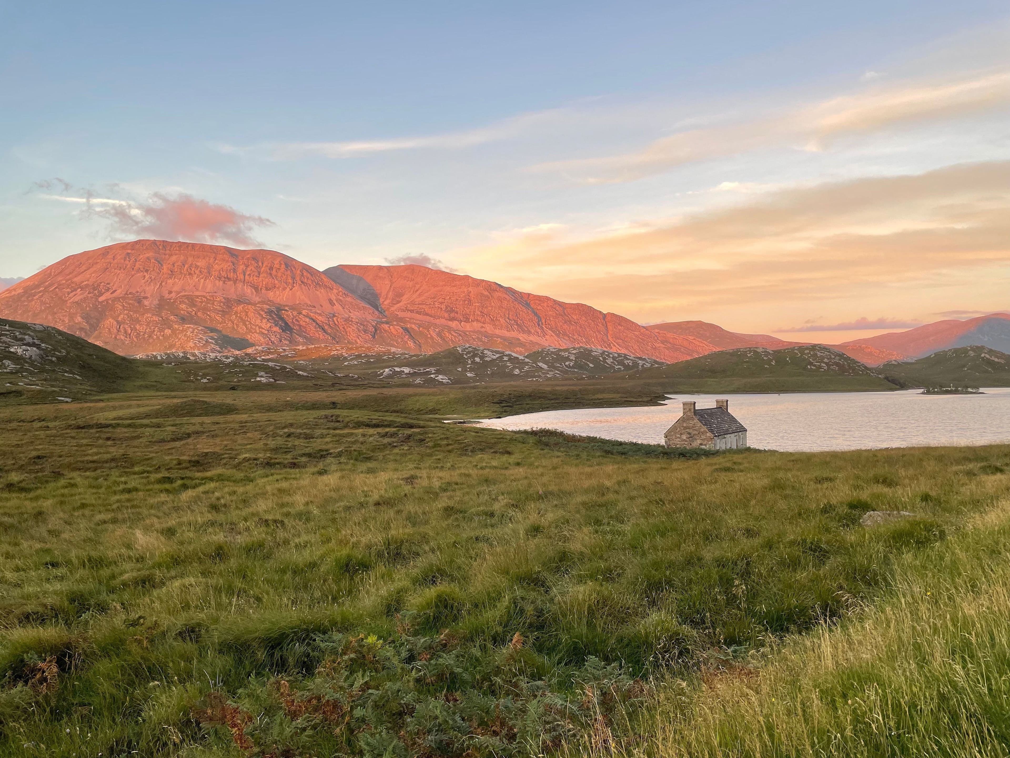 A Scottish Highland loch at golden summer evening light