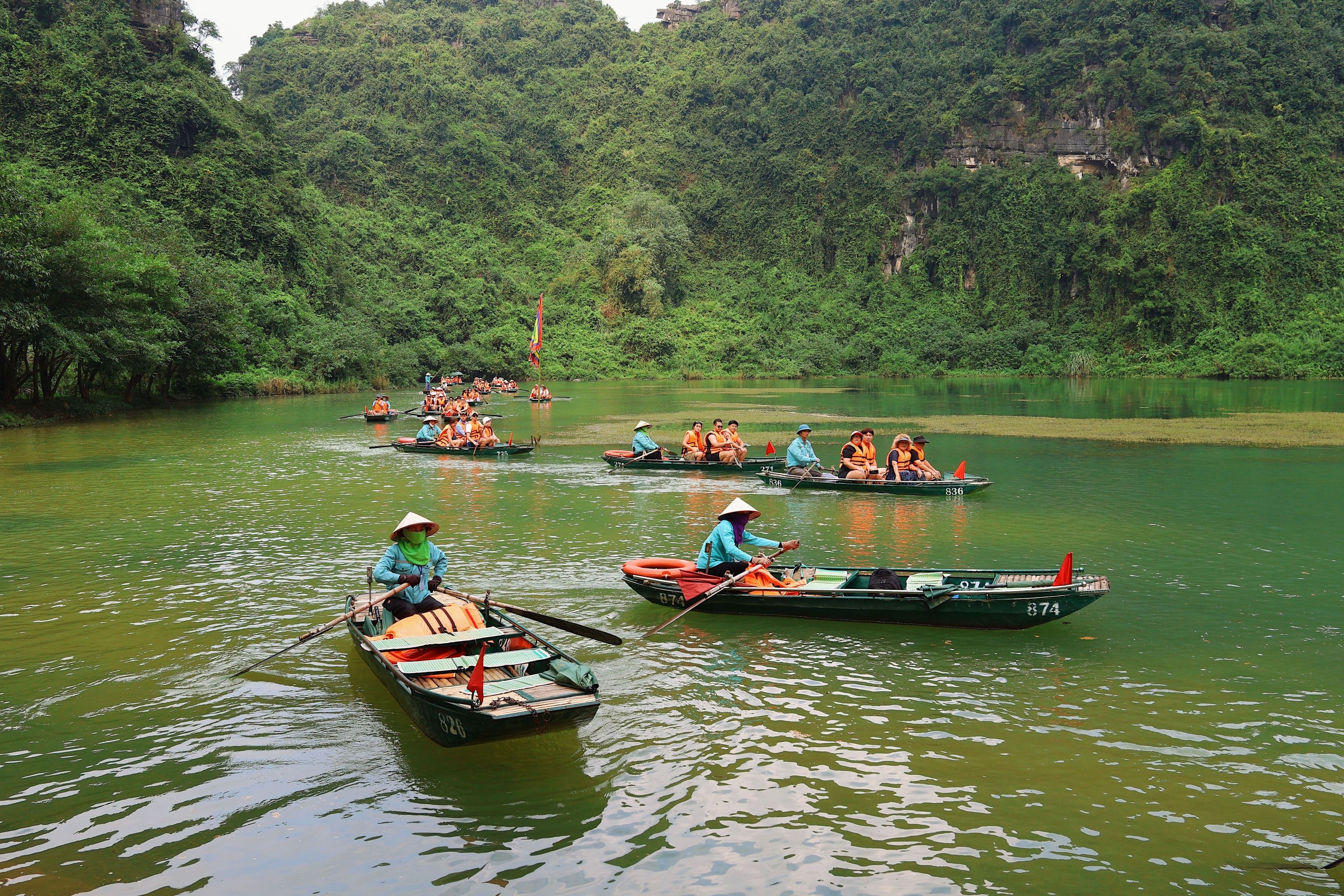 Rowing boats among the karsts at Trang An, Ninh Binh